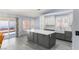 Bright kitchen showcasing an island, gray cabinets, and easy access to the backyard at 5441 Rose Hills St, Las Vegas, NV 89149