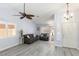 Inviting living room with modern gray flooring, neutral paint, and updated light fixtures at 5441 Rose Hills St, Las Vegas, NV 89149