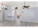 Spacious living room with an open floor plan, gray flooring, and modern ceiling fan at 5441 Rose Hills St, Las Vegas, NV 89149