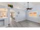 Bright living room showcasing vaulted ceilings, stylish gray flooring, and modern ceiling fan at 5441 Rose Hills St, Las Vegas, NV 89149