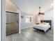 Spacious main bedroom with wood-look floors, ceiling fan, and en suite bathroom with a glass shower at 5441 Rose Hills St, Las Vegas, NV 89149