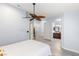 Spacious main bedroom featuring a ceiling fan, wood floors and an ensuite bath with double sinks at 5441 Rose Hills St, Las Vegas, NV 89149