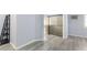 Open main bedroom with wood-look floors and en suite bathroom with glass shower at 5441 Rose Hills St, Las Vegas, NV 89149
