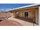 Covered patio with concrete flooring, brick accents, and a sliding glass door at 5441 Rose Hills St, Las Vegas, NV 89149