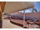 Covered patio overlooking a backyard with a rock garden and minimal landscaping at 5441 Rose Hills St, Las Vegas, NV 89149