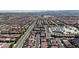 Wide aerial perspective showcasing the vast residential layout of a community, with schools in the distance at 5661 Brimstone Hill Ave, Las Vegas, NV 89141