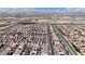 Aerial view displaying a densely populated area of single-Gathering homes, featuring mountains and city views in the background at 5661 Brimstone Hill Ave, Las Vegas, NV 89141