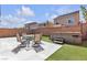 Exterior view of backyard featuring an outdoor dining set and a hot tub at 5661 Brimstone Hill Ave, Las Vegas, NV 89141
