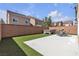 A backyard featuring green artificial turf, a hot tub, and an outdoor patio at 5661 Brimstone Hill Ave, Las Vegas, NV 89141