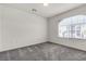 A standard bedroom with gray carpet, window, and neutral paint at 5661 Brimstone Hill Ave, Las Vegas, NV 89141