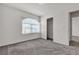 Bedroom featuring a closet with sliding doors, a window, and gray carpet at 5661 Brimstone Hill Ave, Las Vegas, NV 89141
