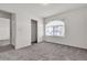 Bedroom featuring carpet flooring, white walls and trim, a large window, and closet at 5661 Brimstone Hill Ave, Las Vegas, NV 89141
