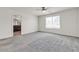 Spacious bedroom featuring carpet flooring, neutral paint, and an open bathroom doorway at 5661 Brimstone Hill Ave, Las Vegas, NV 89141