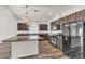 Modern kitchen with stainless steel appliances, a large island, and dark wood cabinets at 5661 Brimstone Hill Ave, Las Vegas, NV 89141