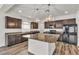 Modern kitchen with granite countertops, stainless steel appliances, and a center island at 5661 Brimstone Hill Ave, Las Vegas, NV 89141