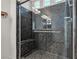 The walk-in shower features dark stone, built-in bench, and shower head at 5661 Brimstone Hill Ave, Las Vegas, NV 89141