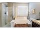 Bright bathroom with a glass shower, soaking tub, and granite countertop at 5854 Willow Trace Ave, Las Vegas, NV 89139