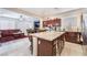 Modern kitchen featuring an island with granite countertops and wood cabinets at 5854 Willow Trace Ave, Las Vegas, NV 89139