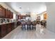 Spacious kitchen with modern appliances, dark cabinets, granite counters and breakfast bar with seating at 5854 Willow Trace Ave, Las Vegas, NV 89139