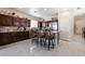 Bright kitchen with dark cabinets, granite counters, stainless steel appliances and a breakfast bar with seating at 5854 Willow Trace Ave, Las Vegas, NV 89139