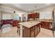 Open concept kitchen with dark cabinets, granite counters, breakfast bar with seating and tile floors at 5854 Willow Trace Ave, Las Vegas, NV 89139