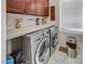Laundry room with front loading washer and dryer and storage cabinets at 5854 Willow Trace Ave, Las Vegas, NV 89139