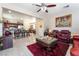 Open concept living room and kitchen with dark cabinets, granite counters and tile floors at 5854 Willow Trace Ave, Las Vegas, NV 89139