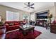 Cozy living room with modern furnishings, tile floors, ceiling fan and fireplace at 5854 Willow Trace Ave, Las Vegas, NV 89139