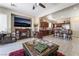 Open concept living room and kitchen area with dark cabinets, granite counters and stainless steel appliances at 5854 Willow Trace Ave, Las Vegas, NV 89139