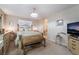 Elegant main bedroom with chandelier, plush bedding, and ensuite access at 5854 Willow Trace Ave, Las Vegas, NV 89139