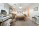 Elegant main bedroom with chandelier, plush bedding, and vanity area at 5854 Willow Trace Ave, Las Vegas, NV 89139