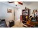 Inviting home office with a ceiling fan, a brown leather sofa and seat, and traditional wooden desk at 5854 Willow Trace Ave, Las Vegas, NV 89139
