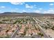 Aerial view of a community with mountain views, showcasing the neighborhood and surrounding landscape at 5937 Round Castle St, Las Vegas, NV 89130