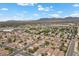 Expansive aerial view of a residential community showcasing the well-planned streets, diverse homes, and surrounding landscape at 5937 Round Castle St, Las Vegas, NV 89130