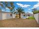 A serene backyard with a pool, mature palm tree, an outdoor structure, and gravel landscaping at 5937 Round Castle St, Las Vegas, NV 89130