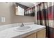 Simple bathroom featuring a white sink, white tiled countertop, and a colorful shower curtain at 5937 Round Castle St, Las Vegas, NV 89130