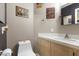 Modest powder room with a classic white toilet and a simple sink setup with hot rod themed decorations at 5937 Round Castle St, Las Vegas, NV 89130