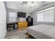 Bedroom with wood-look flooring, closet, TV and plentiful natural light at 5937 Round Castle St, Las Vegas, NV 89130