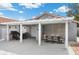A covered patio with a grill, dining area, and an attached pergola enhance outdoor living at 5937 Round Castle St, Las Vegas, NV 89130