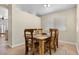 Bright dining room features a wooden table set, tile floors, and a window providing natural light at 5937 Round Castle St, Las Vegas, NV 89130