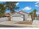 Single-story home featuring an attached two car garage and drought tolerant landscaping at 5937 Round Castle St, Las Vegas, NV 89130
