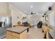 The kitchen is open to the living room and has wooden cabinets, tile floors, and stainless steel appliances at 5937 Round Castle St, Las Vegas, NV 89130