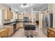 The kitchen features wooden cabinets, stainless steel appliances, a kitchen island, and tile floors at 5937 Round Castle St, Las Vegas, NV 89130