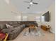 Spacious living room featuring a large sofa, ceiling fan, and mounted television at 5937 Round Castle St, Las Vegas, NV 89130
