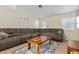 Inviting living room with a sofa, ceiling fan, and wall decor, creating a welcoming atmosphere at 5937 Round Castle St, Las Vegas, NV 89130