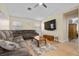 Comfortable living room featuring a large sectional sofa, ceiling fan, and mounted television at 5937 Round Castle St, Las Vegas, NV 89130