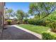 Landscaped backyard with artificial turf, mature landscaping, and a paved patio area at 6049 Paddleboat St, North Las Vegas, NV 89031