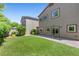Backyard featuring artificial turf, mature landscaping, paved patio, and a well maintained exterior at 6049 Paddleboat St, North Las Vegas, NV 89031