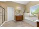 Bathroom featuring a bathtub, glass enclosed shower, double vanity, and white wood cabinets at 6049 Paddleboat St, North Las Vegas, NV 89031