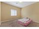 Bright bedroom with a window, neutral walls, and carpeted floors, creating a simple and comfortable atmosphere at 6049 Paddleboat St, North Las Vegas, NV 89031